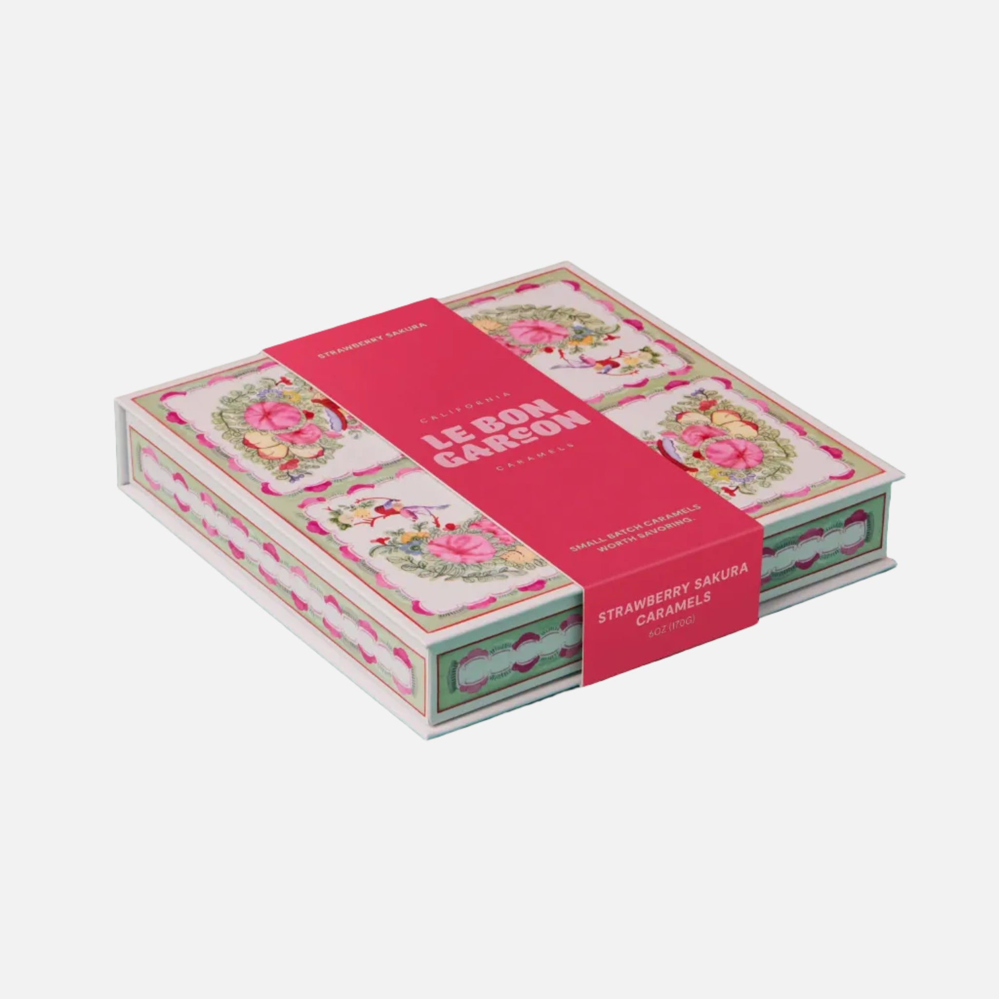 Card game box with floral design on a teal background