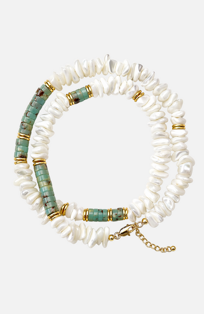 Stack of white beaded bracelets with turquoise and gold accents on a white background