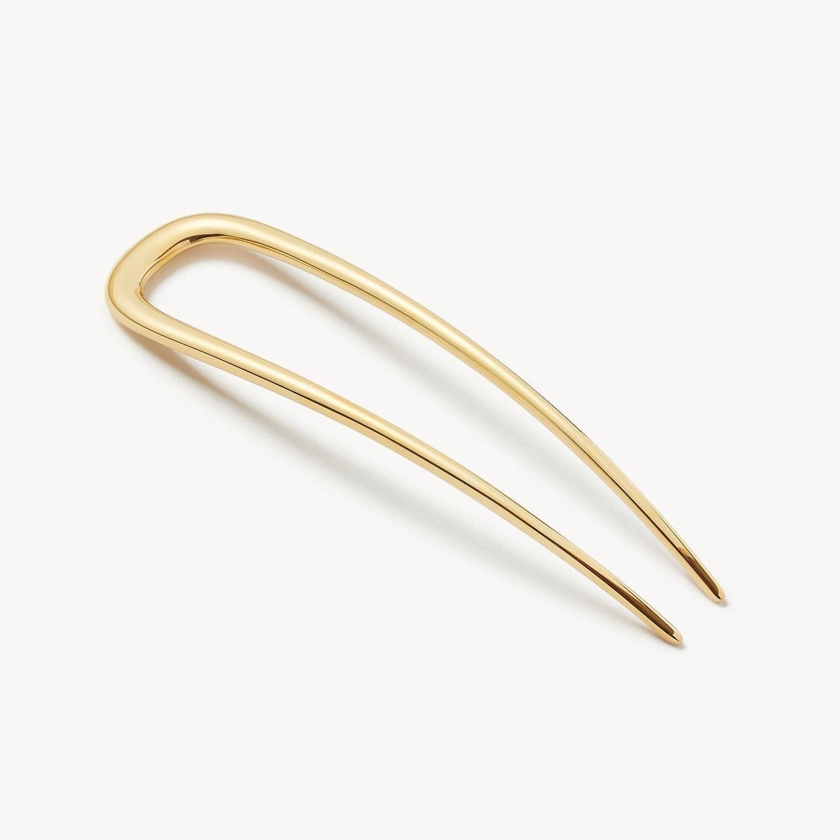 Gold hairpin on a white background