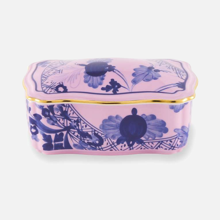 Oriente Italiano rectangular box with cover in Azalea, a pink porcelain box with hand-painted blue florals and a gold rim.