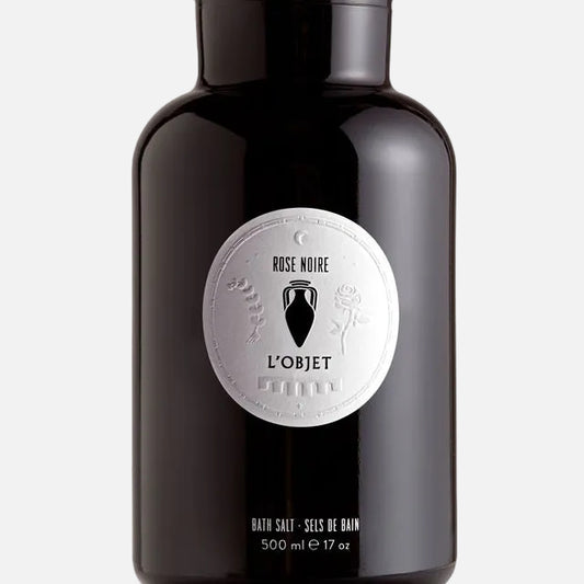 Black bottle of L'Objet Rose Noire bath salt on a white background