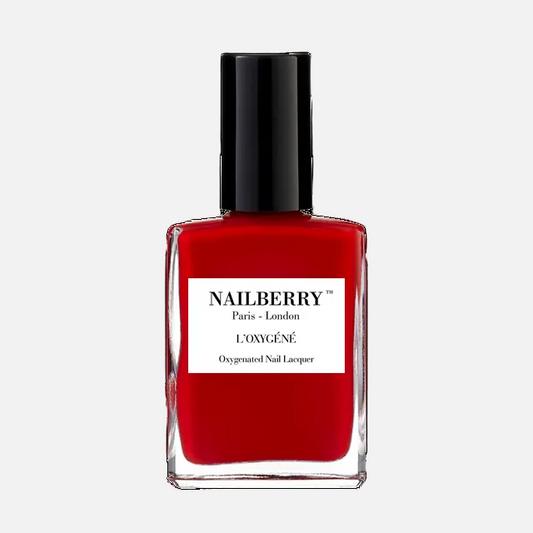 Red nail polish bottle with black cap on a white background